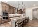 Spacious kitchen with central island, breakfast bar, stainless appliances, and tiled flooring at 26999 W Ponderosa Ln, Buckeye, AZ 85396