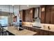 Elegant kitchen featuring a large island, custom cabinets, and modern appliances at 26999 W Ponderosa Ln, Buckeye, AZ 85396