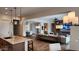 Open-concept living room features hardwood floors, a ceiling fan, and views into the kitchen and dining room at 26999 W Ponderosa Ln, Buckeye, AZ 85396