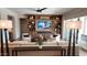 Cozy living room with custom built-ins, a fireplace, and a view to the backyard at 26999 W Ponderosa Ln, Buckeye, AZ 85396