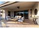 Comfortable covered patio with stylish seating, ideal for outdoor entertaining and relaxing at 26999 W Ponderosa Ln, Buckeye, AZ 85396