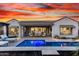 Stunning backyard pool with an outdoor seating area, covered patio, and landscaped surroundings at 26999 W Ponderosa Ln, Buckeye, AZ 85396