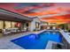 Beautiful backyard pool with outdoor seating, lounge chairs, and covered patio at 26999 W Ponderosa Ln, Buckeye, AZ 85396
