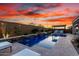 Relaxing backyard pool with water feature, privacy wall, and pergola sitting area at sunset at 26999 W Ponderosa Ln, Buckeye, AZ 85396