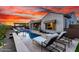 Gorgeous backyard pool with sun loungers, outdoor seating, and mature desert landscaping at 26999 W Ponderosa Ln, Buckeye, AZ 85396