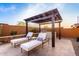 Comfortable lounge chairs under a shaded pergola with a built-in grill at 26999 W Ponderosa Ln, Buckeye, AZ 85396