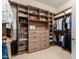 Spacious walk-in closet with custom shelving, drawers, and hanging rods for organized storage at 26999 W Ponderosa Ln, Buckeye, AZ 85396
