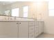 Bright bathroom boasts double vanity with white countertop and sleek cabinetry with modern gold hardware at 2896 E Maplewood St, Gilbert, AZ 85297