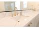 Close-up of a stylish bathroom vanity featuring white countertop, modern faucet, and elegant gold hardware at 2896 E Maplewood St, Gilbert, AZ 85297