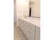 Bathroom featuring a double vanity with light-colored cabinets, white countertop and modern gold hardware at 2896 E Maplewood St, Gilbert, AZ 85297