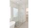 Contemporary bathroom featuring a glass-enclosed shower and white-tiled walls at 2896 E Maplewood St, Gilbert, AZ 85297