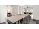 Bright dining room features a long table with seating for eight, seamlessly connecting to the living spaces at 2896 E Maplewood St, Gilbert, AZ 85297