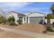 Well-maintained home featuring a tile roof, a brick driveway, and a two-car garage at 2896 E Maplewood St, Gilbert, AZ 85297