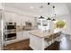 Gourmet kitchen featuring granite countertops, stainless steel appliances, pendant lighting, and a large kitchen island at 2896 E Maplewood St, Gilbert, AZ 85297