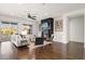 Open-concept living room with a fireplace, hardwood floors, modern decor, and ample natural light at 2896 E Maplewood St, Gilbert, AZ 85297