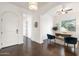 Home office with hardwood floors, arched doorways, a window, and a comfortable seating area at 2896 E Maplewood St, Gilbert, AZ 85297