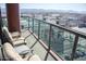 Relax on this balcony with cushioned chairs and a glass railing overlooking a city and mountain view at 310 S 4Th St # 901, Phoenix, AZ 85004