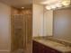 Modern bathroom with a glass-enclosed shower, double sinks, and granite countertops at 310 S 4Th St # 901, Phoenix, AZ 85004