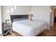 Comfortable bedroom with hardwood floors, a black headboard, and a view to a hallway at 310 S 4Th St # 901, Phoenix, AZ 85004
