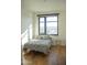Cozy bedroom with a large window, a light gray bed and hardwood floors at 310 S 4Th St # 901, Phoenix, AZ 85004