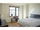 Bright bedroom with a city view, light walls, hardwood floors and black furniture at 310 S 4Th St # 901, Phoenix, AZ 85004