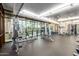 Bright gym with modern exercise equipment, rubber flooring, and large windows with a cityscape view at 310 S 4Th St # 901, Phoenix, AZ 85004