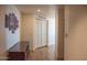 Hallway featuring hardwood floors, white walls with art and a dark wood cabinet for storage at 310 S 4Th St # 901, Phoenix, AZ 85004