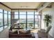 Inviting living room with floor-to-ceiling windows and access to balcony with expansive city views at 310 S 4Th St # 901, Phoenix, AZ 85004