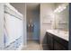 Bright bathroom featuring a dual sink vanity, decor shelves and a shower/tub combination at 31045 W Mulberry Dr, Buckeye, AZ 85396