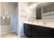 Bright bathroom featuring a dual sink vanity, decor shelves and a shower/tub combination at 31045 W Mulberry Dr, Buckeye, AZ 85396
