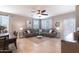 Comfortable living room with a modern ceiling fan, neutral decor and a view to the dining area at 31045 W Mulberry Dr, Buckeye, AZ 85396