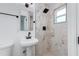 Stylish bathroom featuring marble tile, a modern vanity, and a shower with matte black fixtures at 3330 E Palm Ln, Phoenix, AZ 85008