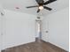 Well-lit bedroom featuring wood-look flooring, white walls, a ceiling fan, and a closet at 3330 E Palm Ln, Phoenix, AZ 85008