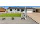 Charming home exterior with manicured lawn, gravel landscaping, and a pristine white facade at 3330 E Palm Ln, Phoenix, AZ 85008