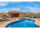 Expansive backyard featuring a pool, covered patio, and plenty of space for outdoor living at 37161 W Giallo Ln, Maricopa, AZ 85138