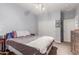 Bedroom boasts natural light, ceiling fan, and closet with sliding doors at 37161 W Giallo Ln, Maricopa, AZ 85138