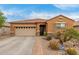 Charming single-story home with desert landscaping, two-car garage and security system at 37161 W Giallo Ln, Maricopa, AZ 85138