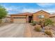 Charming single-story home with desert landscaping, two-car garage and security system at 37161 W Giallo Ln, Maricopa, AZ 85138