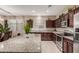 Kitchen with granite countertops, stainless steel appliances, a large island, and neutral tones at 37161 W Giallo Ln, Maricopa, AZ 85138