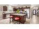 Kitchen with granite countertops, stainless steel appliances, kitchen island and tiled floors at 37161 W Giallo Ln, Maricopa, AZ 85138