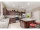 Kitchen with granite counters, stainless steel appliances, and kitchen island with seating at 37161 W Giallo Ln, Maricopa, AZ 85138