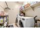 A clean laundry room with shelving, a washer and dryer set, and a laundry mat at 37161 W Giallo Ln, Maricopa, AZ 85138