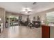 Spacious living room with tile flooring, ceiling fan, and access to the backyard pool at 37161 W Giallo Ln, Maricopa, AZ 85138