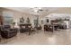 Inviting living room with tile flooring, neutral walls, and an open floor plan into kitchen and dining at 37161 W Giallo Ln, Maricopa, AZ 85138