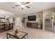 Bright living room featuring tile flooring and neutral colored walls with open access to kitchen at 37161 W Giallo Ln, Maricopa, AZ 85138