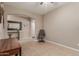 Comfortable living area with sofa, desk, and neutral tile flooring at 37161 W Giallo Ln, Maricopa, AZ 85138