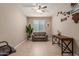 Comfortable living area with sofa, desk, and natural light at 37161 W Giallo Ln, Maricopa, AZ 85138