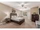 Carpeted main bedroom with large windows and ceiling fan, features neutral paint and a calm aesthetic at 37161 W Giallo Ln, Maricopa, AZ 85138