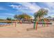Playground with several structures, a rainbow, and a pond nearby at 37161 W Giallo Ln, Maricopa, AZ 85138