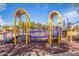 Playground with a bridge and shade structures, with a pond nearby at 37161 W Giallo Ln, Maricopa, AZ 85138